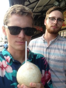 Drinking a coconut from a street market.