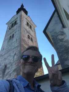 Me on the island of Lake Bled with the Assumption of Mary Church.  The bell tower is 171 feet high and you can walk to the top.